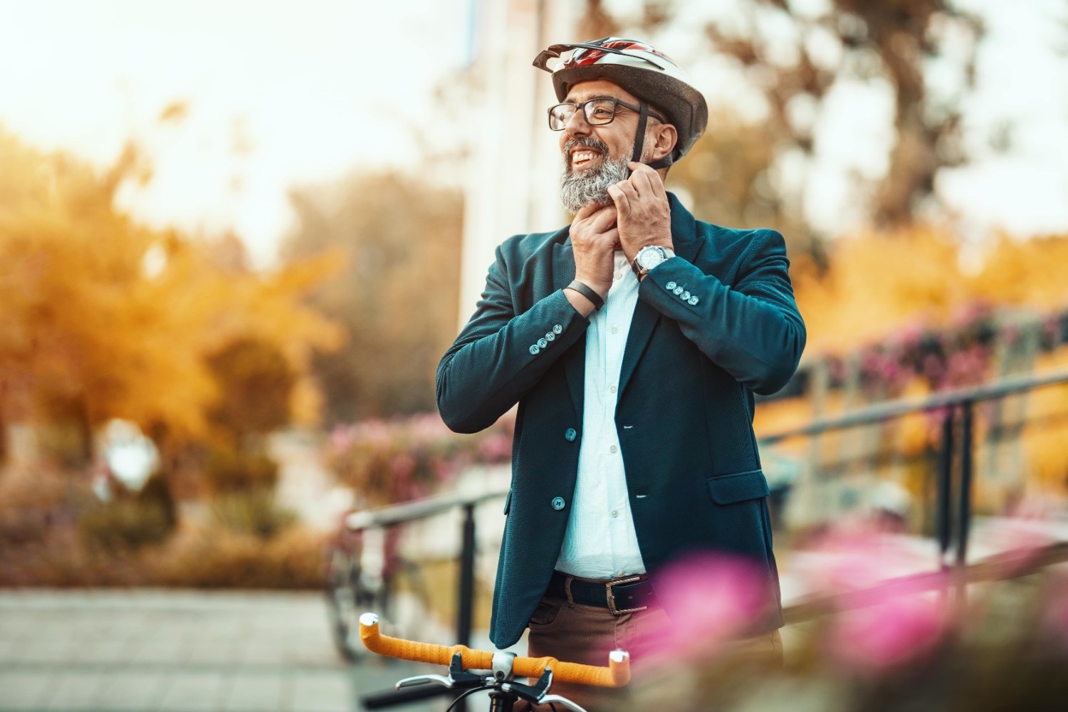 Gospod si veselo namešča čelado na glavo in se odpravlja na vožnjo s kolesom